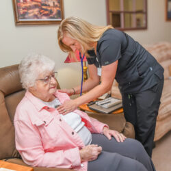 Caregiver listening to a patient's heart